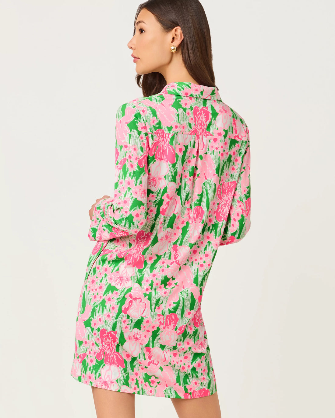 Woman wearing a pink floral dress on a white background