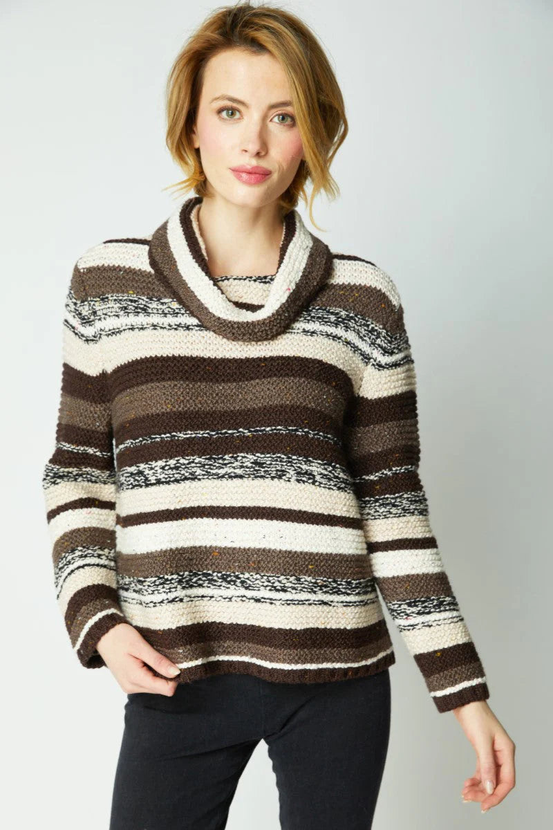 Woman wearing a striped sweater with a plain background